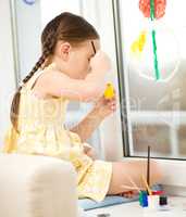 Portrait of a cute girl playing with paints