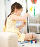 Portrait of a cute girl playing with paints