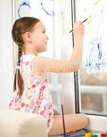 Portrait of a cute girl playing with paints