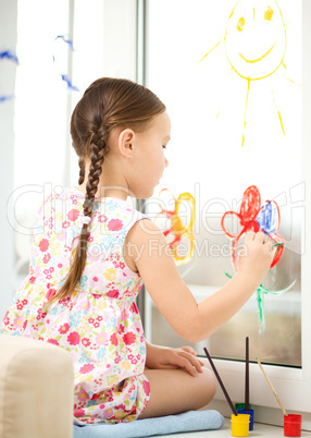 Portrait of a cute girl playing with paints