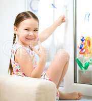 Portrait of a cute girl playing with paints