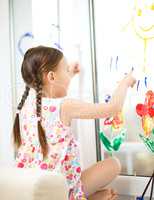 Portrait of a cute girl playing with paints