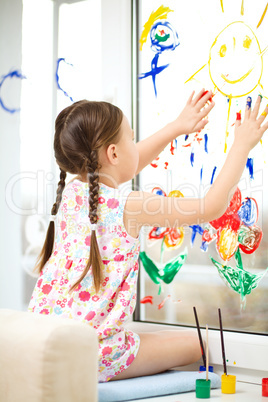 Portrait of a cute girl playing with paints