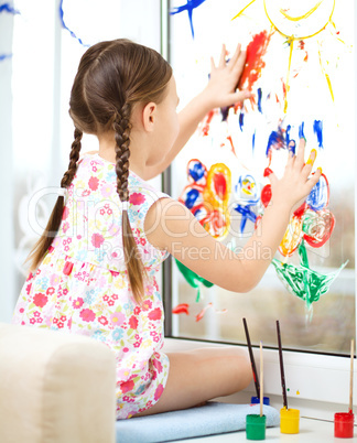 Portrait of a cute girl playing with paints