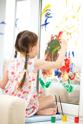 Portrait of a cute girl playing with paints