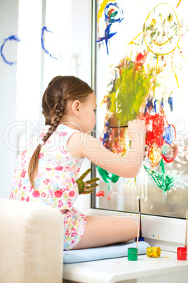 Portrait of a cute girl playing with paints