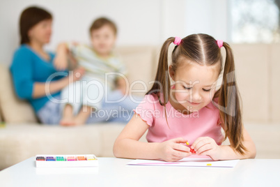 Little girl is playing with plasticine