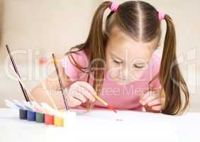 Cute cheerful child play with paints