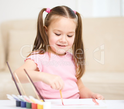 Cute cheerful child play with paints