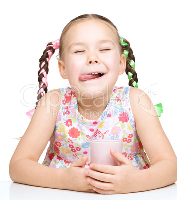 Cute little girl with a glass of milk