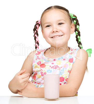 Cute little girl with a glass of milk