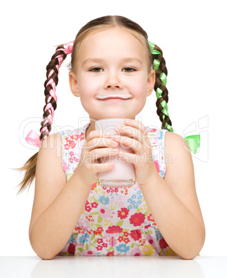 Cute little girl showing milk moustache