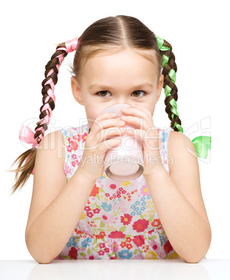 Cute little girl with a glass of milk