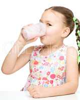 Cute little girl with a glass of milk