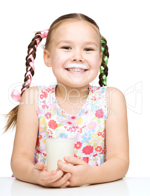 Cute little girl showing milk moustache