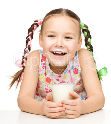 Cute little girl showing milk moustache