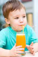 Little boy with glass of orange juice