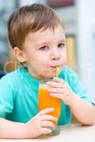 Little boy with glass of orange juice