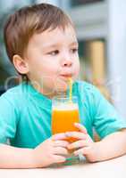 Little boy with glass of orange juice