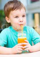 Little boy with glass of orange juice