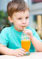 Little boy with glass of orange juice