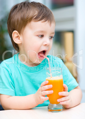 Little boy with glass of orange juice