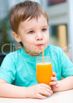 Little boy with glass of orange juice