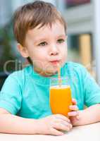 Little boy with glass of orange juice