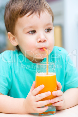 Little boy with glass of orange juice