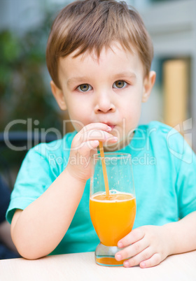 Little boy with glass of orange juice