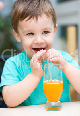 Little boy with glass of orange juice