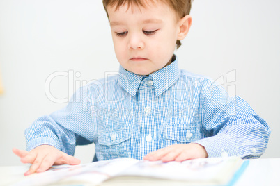 Little boy is reading book