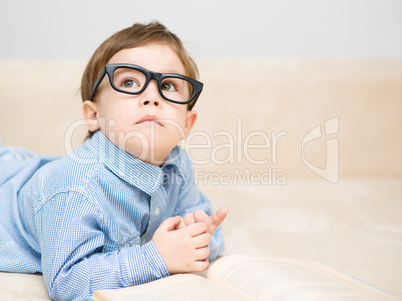 Little boy is reading book