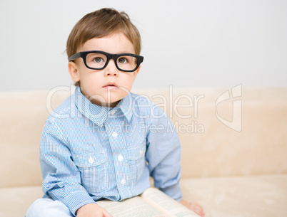 Little boy is reading book