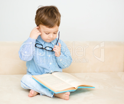 Little boy is reading book