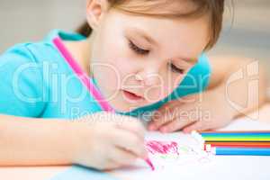 Cute cheerful child drawing using felt-tip pen