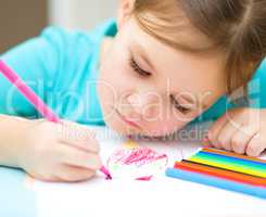 Cute cheerful child drawing using felt-tip pen