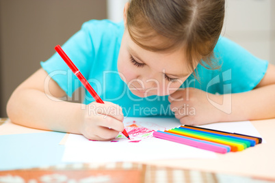 Cute cheerful child drawing using felt-tip pen