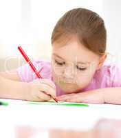 Cute cheerful child drawing using felt-tip pen