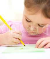 Cute cheerful child drawing using felt-tip pen