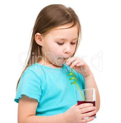 Little girl is drinking cherry juice