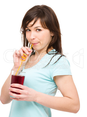 Young woman is drinking cherry juice