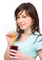 Young woman is drinking cherry juice