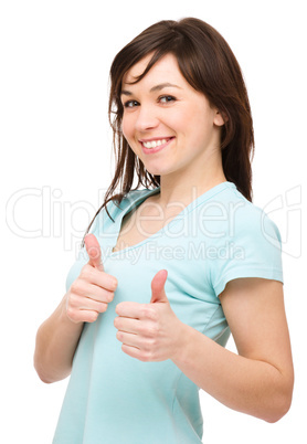 Woman is showing thumb up gesture