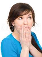 Woman is covering her mouth in astonishment