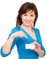 Young woman is holding visit card