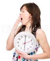 Young woman is holding big clock