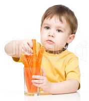 Little boy is eating carrot