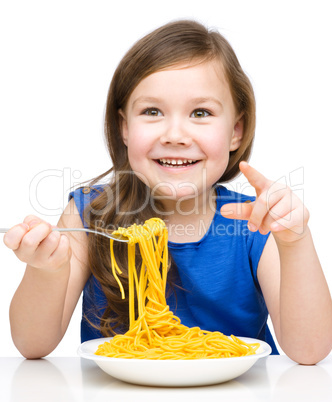 Little girl is eating spaghetti