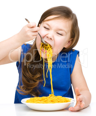 Little girl is eating spaghetti